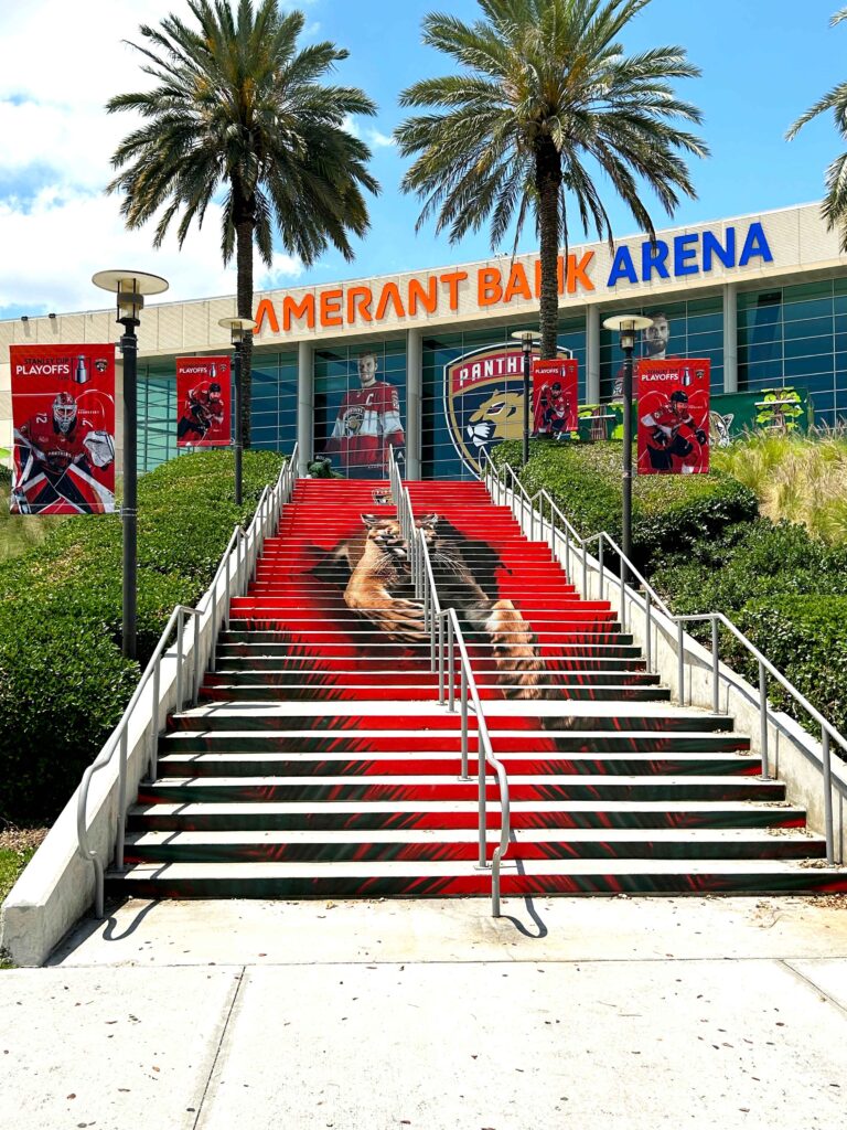 Branded entrance graphics and stairway installation at Amerant Bank Arena.