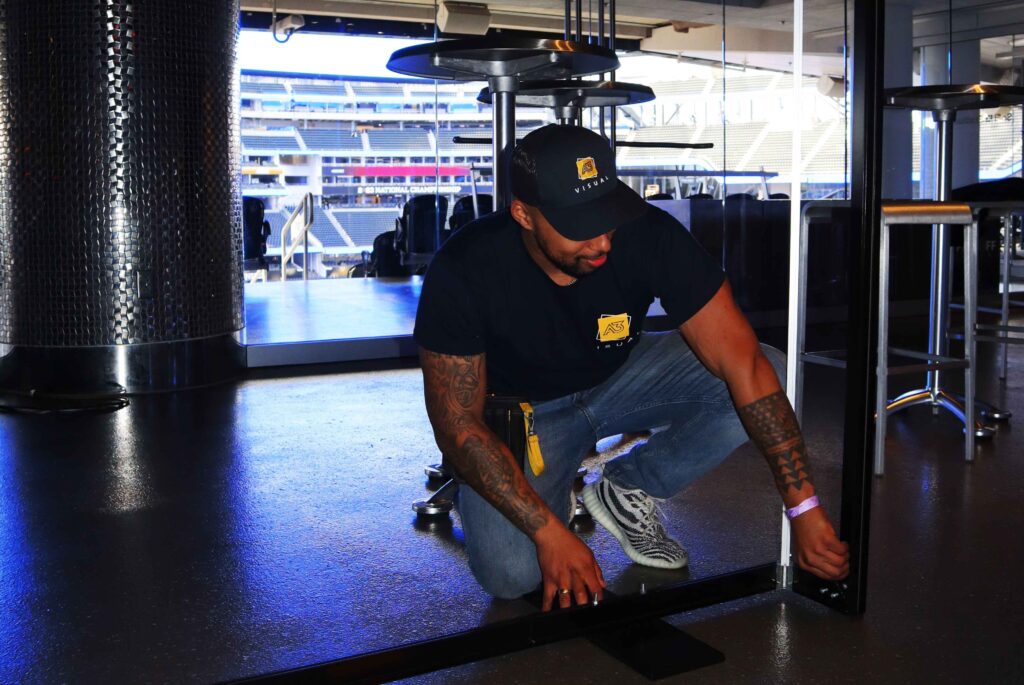 A3 Visual installation team applying floor graphics at NRG Stadium for the 2024 College Football Playoff National Championship.