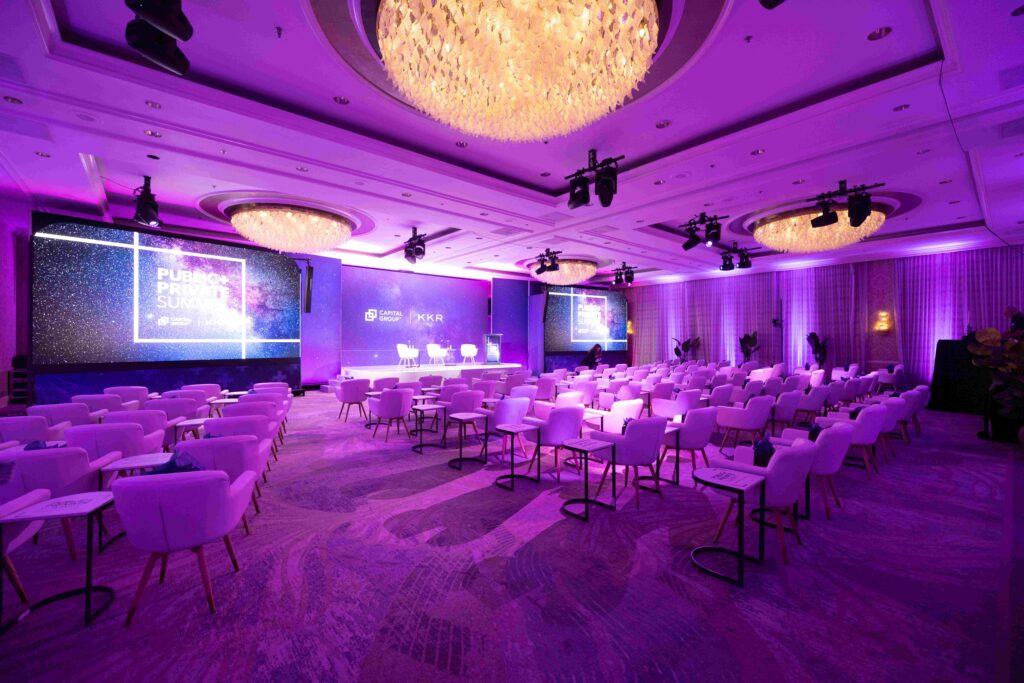 Corporate event environment featuring custom stage graphics and immersive event branding.