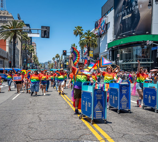 A3 Visual-supported community parade celebrating diversity and inclusion with branded mobile displays during a public event in Hollywood.
